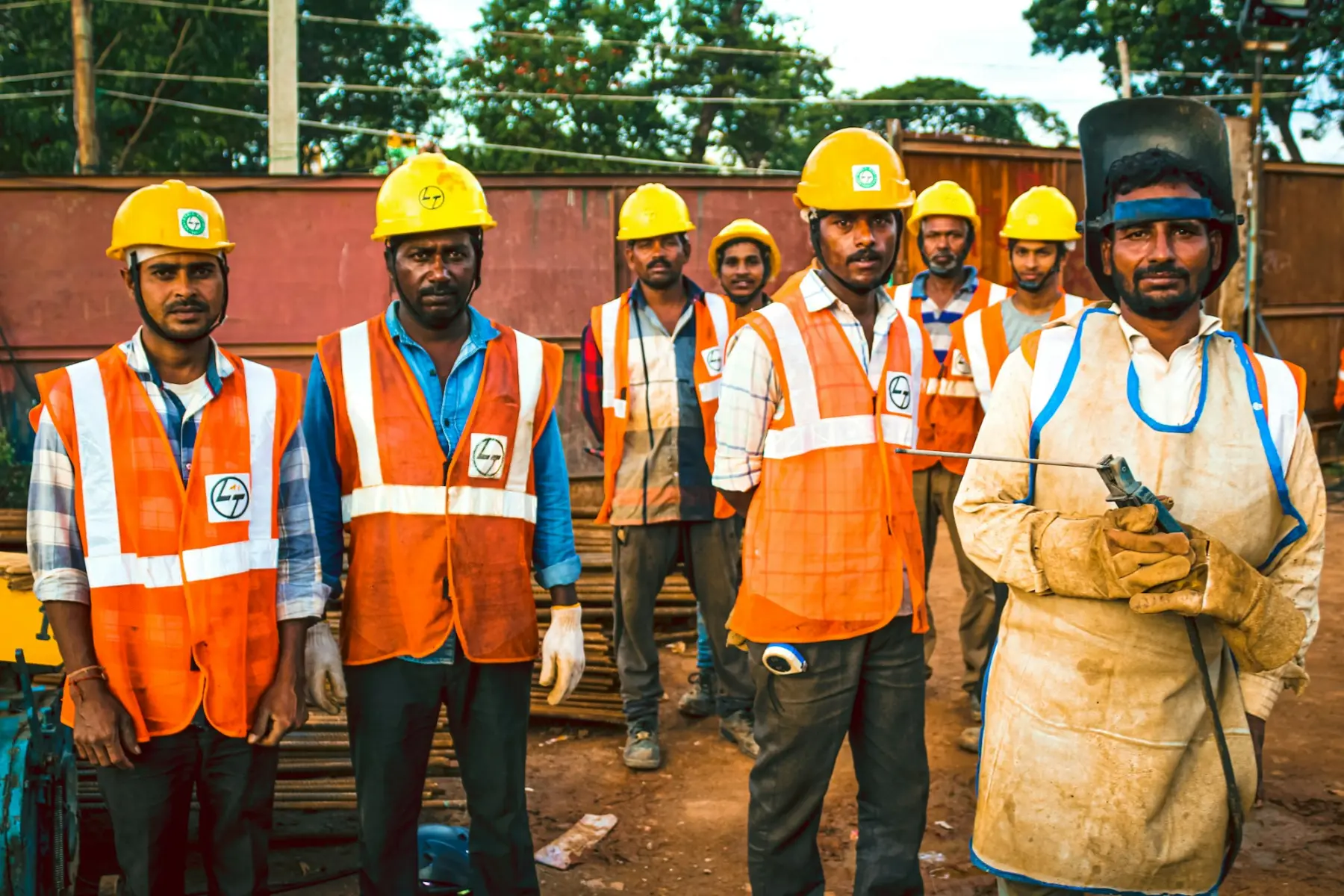 A construction site team in hard hats and reflective vests