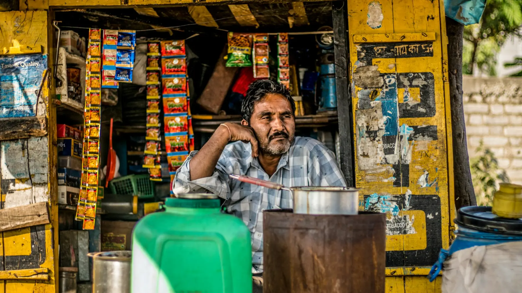 A trader seated at the counter of his shop